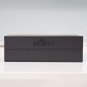 A plain black crafted gift box with giftsdirect logo against a pale grey background. A plain black crafted gift box with giftsdirect logo against a pale grey background.